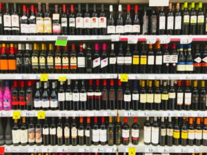 Some shelves with a big variety of wine bottles