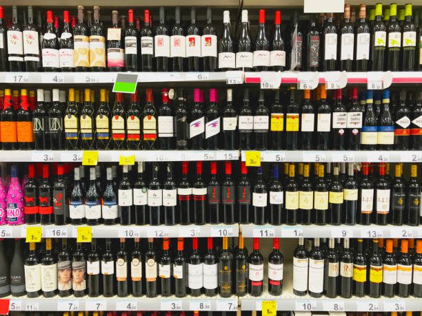 Some shelves with a big variety of wine bottles